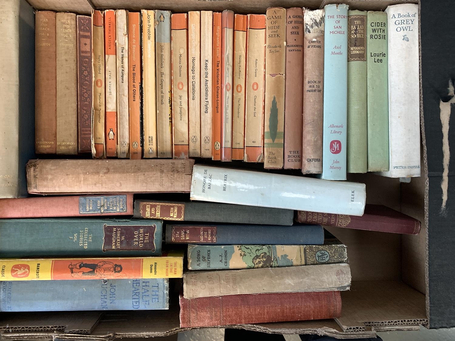 A mixed box of books to include some penguin paperbacks; Laurie Lee, John Steinbeck, Robert