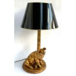 A gilt effect resin table lamp, the base in the form of a recumbent pig, 60cmH to top of fitting;