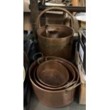 A copper and brass banded coal bucket, 28cmD, together with a graduating set of 3 copper pans and
