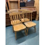 A harlequin set of four large beechwood kitchen chairs