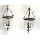 A pair of glass Hundi lights, approx 85cm to top of fitting