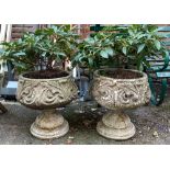 A pair of composite stone garden urn planters, 48cm high