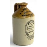 A stoneware flagon with loop handle marked JL Reid & Co, Wimbledon, 26.5 cmH