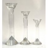 Graduating set of 3 cut glass candlesticks, terminals of faceted conical form, the largest 25.5cmH