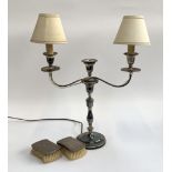 A pair of silver clothes brushes together with a three arm plated candlestick converted for