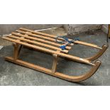A Davos 90 beechwood child's sled, 91cmL