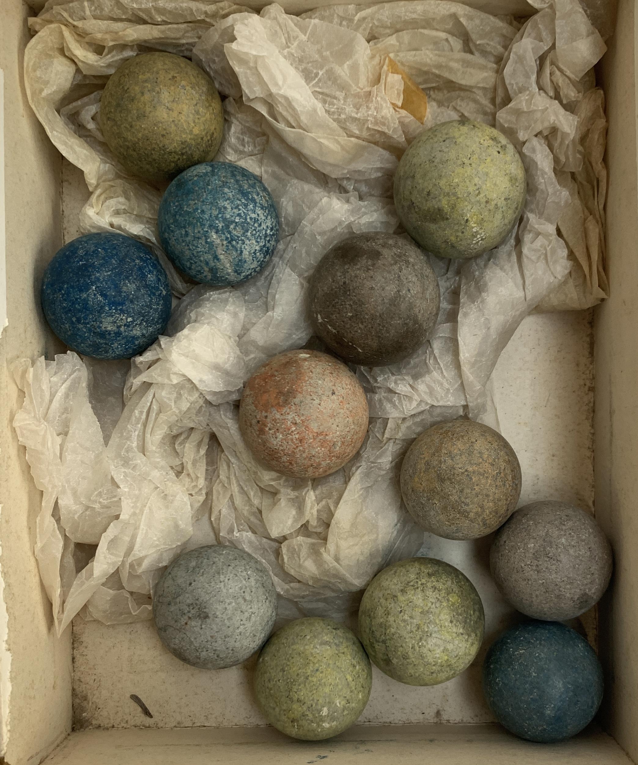12 clay coloured marbles of varying sizes
