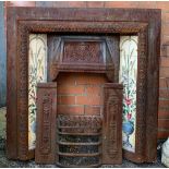 A cast iron tiled fire surround, 95cmW