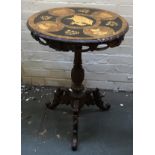 A circular marquetry occasional table, depicting impala, stags and other horned beasts, on a