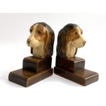 An early 20th century pair of carved and painted bookends of basset hounds/hunting dogs