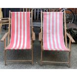 A pair of vintage deck chairs in a pink striped fabric