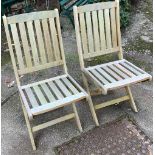 A pair of teak folding garden chairs