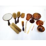 A vintage faux tortoiseshell dressing table set, to include looking glass, trinket pots, brushes,