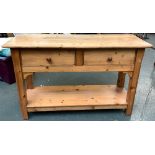 A pine sideboard, with two drawers, on chamfered square section legs with undershelf, 131x48x81cm
