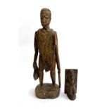Inscribed Victor M, tribal carving of a man with quarry and spear, 63cmH; together with a carved