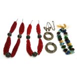 A lot of two Middle Eastern multi-strand coral and white metal necklaces, 76cmL and 72cmL; a pair of