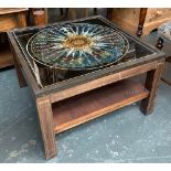 A campaign style brass bound coffee table, glass inset top depicting the points of a compass, with