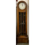 An oak domed long case clock, white enamel dial with Arabic numerals, with glazed trunk, with