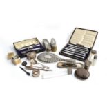 A mixed lot of silver items, to include chased silver looking glass, clothes brushes, lidded