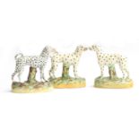 A pair of Staffordshire standing dogs, with spot decoration, one with missing tail, 15.5cm high;