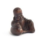 A Japanese carved netsuke in the form of a sage, makers mark to base, 4cm high