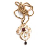 A 9ct Edwardian openwork pendant, set with single oval-cut garnet, with a further garnet suspended