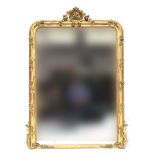 A large French giltwood mirror, floral cresting with all round applied roses and other flowers,
