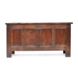 A late 17th/early 18th century oak four panel coffer, 128cm wide, 52cm deep, 85cm high