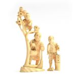 A 19th century Japanese ivory okimono depicting a father and son, the son climbing a flowering