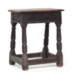 An oak joint stool, carved frieze, on block turned legs and peripheral stretchers, 52cm high