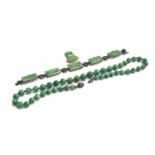 A jade bead necklace, knotted between each bead, with a paste set sterling silver clasp in the