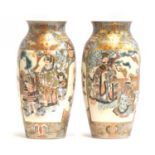 A pair of Japanese Satsuma vases, c.1900, depicting court scenes and chrysanthemums, heightened in