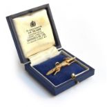 A 9ct gold pendant in the form of a running fox, set with ruby eyes, 4.5cm long approx. 11.2g