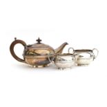 A George V silver three piece tea set by S W Smith & Co, Birmingham 1919, comprising teapot, sugar