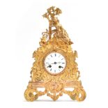 An ornate French ormolu mantel clock, c.1850, the white enamel dial with Roman numerals, within