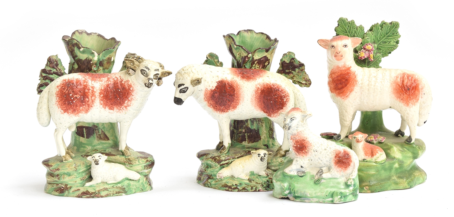 A pair of Staffordshire pearlware spill vases in the form of a ewe and ram, each with lamb, 13cmH;