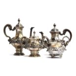 A Portuguese 833 standard silver service, chased with scrolls, comprising teapot, coffee pot, and