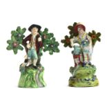 Two early 19th century Staffordshire pearlware figures of gardeners, a lady gardener holding a