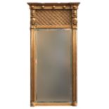 A 19th century Egyptian revival giltwood pier mirror, bobble moulding over blind fretwork, each pier