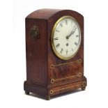 A mahogany and brass inlaid mantel clock, Roman numerals to white enamel dial, on brass ball feet,