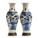 A pair of early 20th century Chinese blue and white crackle glaze vases, depicting birds perched