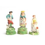 A pair of 19th century Staffordshire pearlware shepherd and shepherdess figures (af), each on a