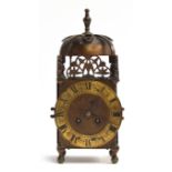 An early 20th century striking lantern clock having a 13cm dial with Roman numerals, the back
