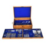 An oak cased canteen of plated kings pattern flatware, with brass loop handles, by Goldsmiths &