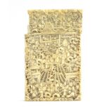 A 19th century Chinese ivory card case, profusely carved with figures, foliage and court scenes,