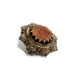 A Victorian silver and goldstone mourning brooch, glass absent on reveverse, hallmarked Edward J