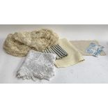 A lace shawl, 114x96"; together with a tablecloth and fabric samples