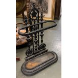 A cast iron stick stand with drip tray, 64cmH