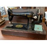 A Singer sewing machine serial no. F885061, in domed mahogany carry case