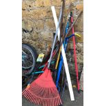 A quantity of long handled garden tools, to include rake, spade, saw etc